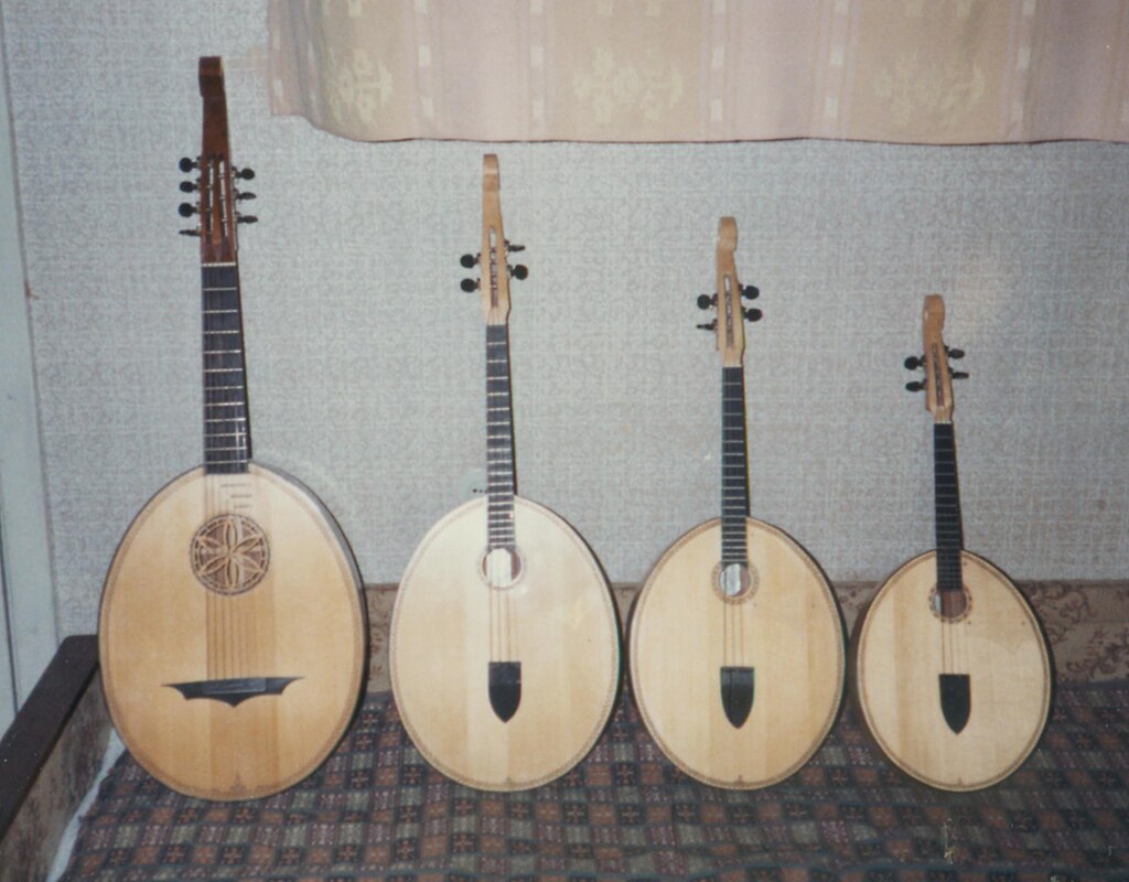 In a row stand four Ukrainian kobza, folk instruments. They are of old production and differ in size, from larger to smaller. The size of the instruments determines their sound.